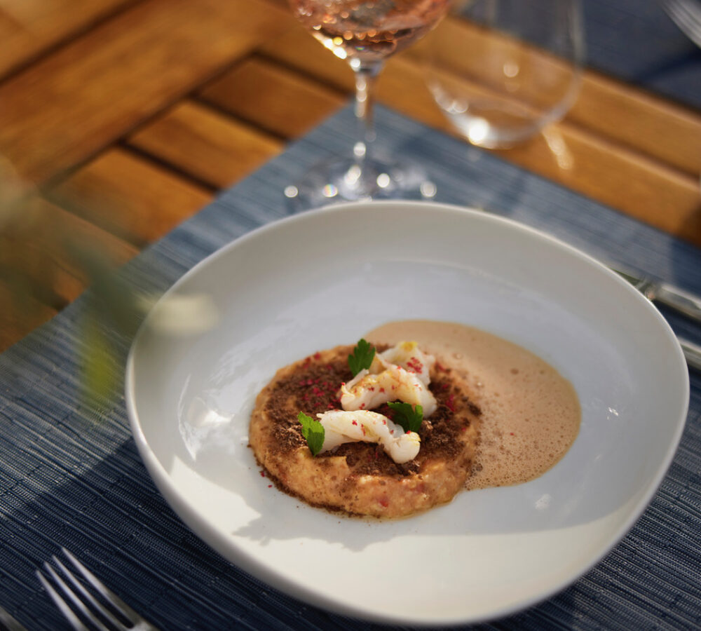 Cretan frumenty xinohontro with crayfish, marinated zucchini and carob croutons